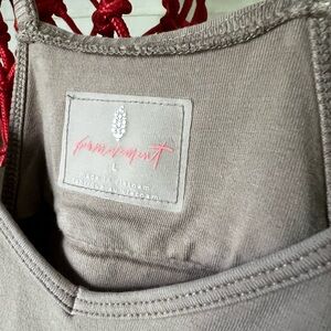 Free People FP Movement Hot Shot Onesie in a tan color, large